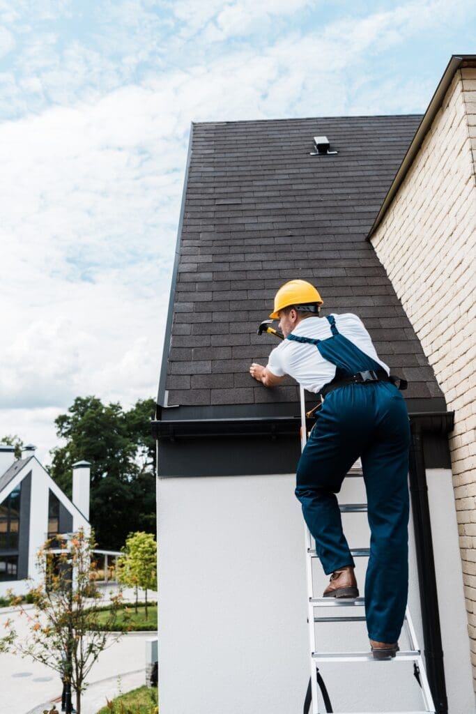 Eternal Roofing Technician Repairing Damaged Shingles on a Roof in Helotes, Texas.